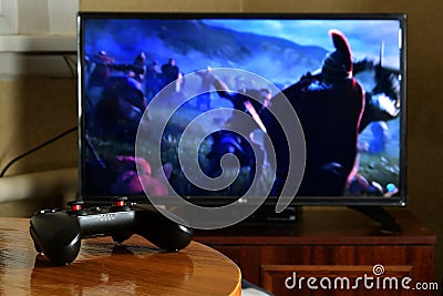 KHARKOV, UKRAINE - NOVEMBER 12, 2020: Video game controller Gamesir g3s on table with Assassins Creed Valhalla game on display Editorial Stock Photo