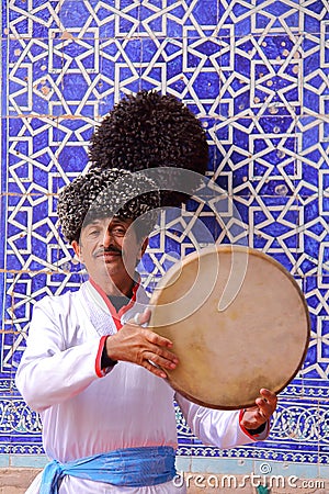 KHIVA, UZBEKISTAN - MAY 4, 2011: Traditional Uzbek musician performing at Tosh Hovli palace Editorial Stock Photo