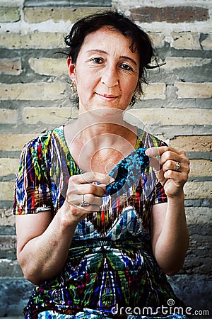 Woman making small knitted shoes for kids Editorial Stock Photo