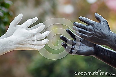 Khmelnytskyi. Ukraine. October 2018. Sculptures by Viktor Sidorenko. Hands of people with white and black skin color. The Editorial Stock Photo