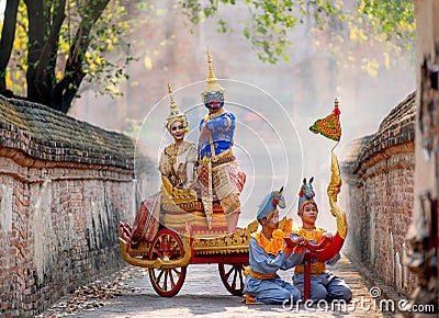 Khon Thai classic masked from the Ramakien with characters of woman and blue monkey stay together on traditional chariot in front Stock Photo