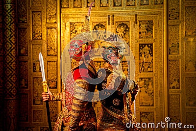 Khon or traditional Thai classic masked from the Ramakien with Red giant stand beside black monkey and Thai paintings background Stock Photo