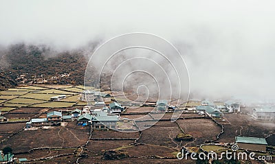 Khumjung Village View with heavy clouds over settlement . Everest Base Camp EBC trekking route. Sagarmatha National Park, Nepal Stock Photo