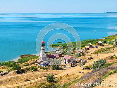 Khutor Merzhanovo, Rostov region, Russia - August 3, 2020: coast of the Azov sea, resting place - huts and a lighthouse Editorial Stock Photo