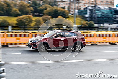 Kia Rio X-Line drive on the road. Red compact hatchback in motion on city highway Editorial Stock Photo