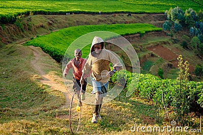 Kibuye/Rwanda - 08/25/2016: African boys playing hoop rolling in Editorial Stock Photo