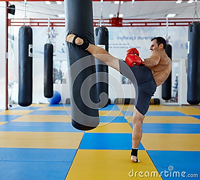 Kickbox fighter training with the punch bag Stock Photo