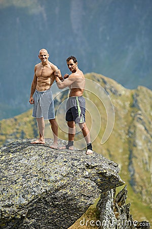 Kickboxers or muay thai fighters training on a mountain cliff Stock Photo