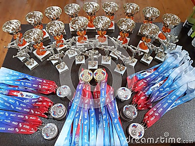 Kickboxing sports awards in the form of cups and medals are on the table. Russia, Sochi 07.21.2019 Editorial Stock Photo