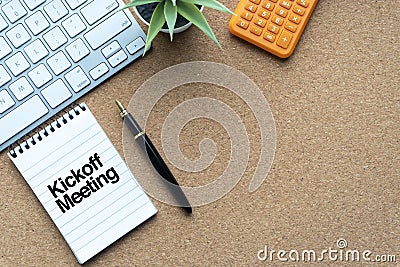 KICKOFF MEETING text with notepad, decorative plant, keyboard and fountain pen on wooden background Stock Photo