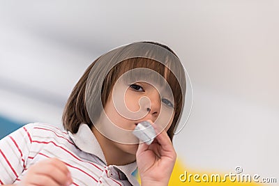 Kid blowing a noisemaker Stock Photo