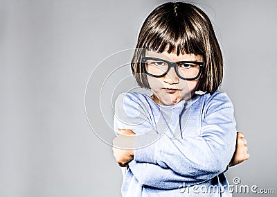 Kid body language with sulking, pouting small child crossing arms Stock Photo
