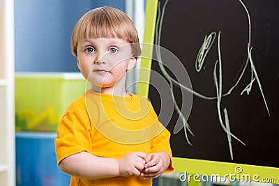 Kid boy chalk drawing on blackboard Stock Photo