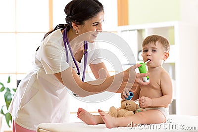 Kid boy having respiratory illness helped by health professional doctor with inhaler Stock Photo