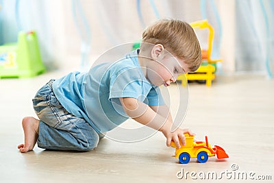 Kid boy toddler playing with toy car Stock Photo