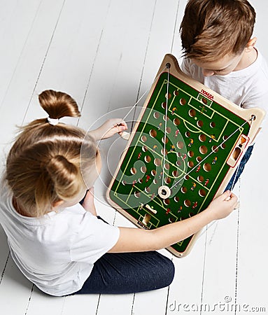 Kid boy watch kid girl playing educational game that developes coordination Stock Photo