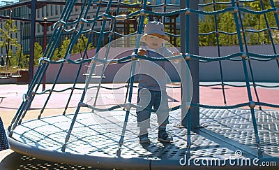 The kid on the carousel on playground Stock Photo