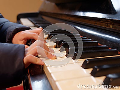 Kid or child hands playing piano closeup Stock Photo