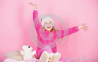 Kid cute girl play with soft toy teddy bear pink background. Unique attachments to stuffed animals. Teddy bears improve Stock Photo