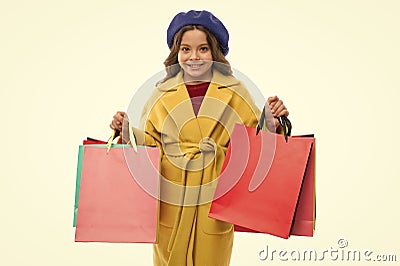 Kid cute little girl hold bunch shopping bags. Child satisfied by shopping isolated white background. Obsessed with Stock Photo