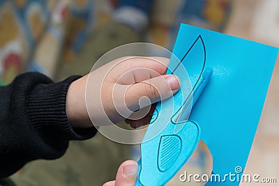 Kid doing paper cutting Stock Photo