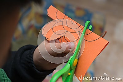 Kid doing paper cutting Stock Photo