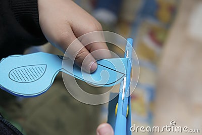 Kid doing paper cutting Stock Photo