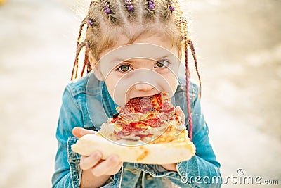 Kid eat pizza. Child eating pizza. Fastfood for kids. Italian junkfood. Children favorite food. Stock Photo