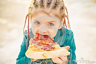 Kid eat pizza. Child eating pizza. Fastfood for kids. Italian junkfood. Children favorite food. Stock Photo