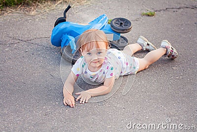 Kid fell down of her bike Stock Photo