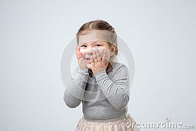Kid getting happy after receiving birthday present from mother Stock Photo
