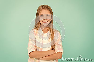 Kid girl blonde hair posing confidently. Girl feels confident with crossed arms. Child hold hands confidently crossed Stock Photo