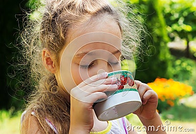 Kid girl drinking water from cup Stock Photo