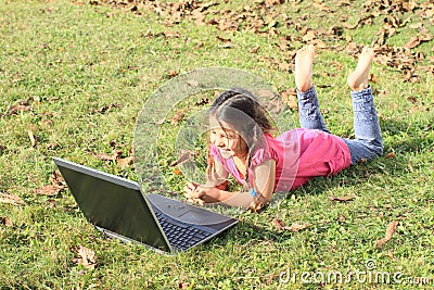 Kid - girl playing with notebook Stock Photo