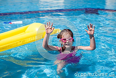 Kid girl playing in the swimming pool. Childhood, summer and vacation concept Stock Photo
