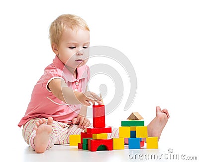 Kid girl playing toy blocks and building tower Stock Photo