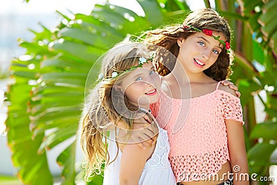 Kid girl sisters hug banana tree leaves bright day Stock Photo