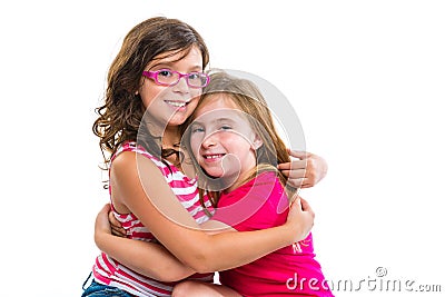 Kid girls tender hug smiling ans friends cousins Stock Photo