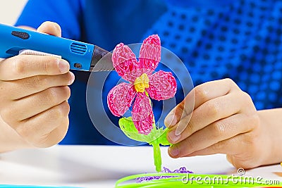 Kid hands creating with blue 3d printing pen Stock Photo