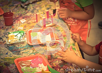 Kid hands painting craft at building workshop in local hardware store in Texas, USA Stock Photo