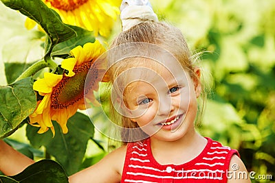 Kid holding sunflower outdoor. Stock Photo