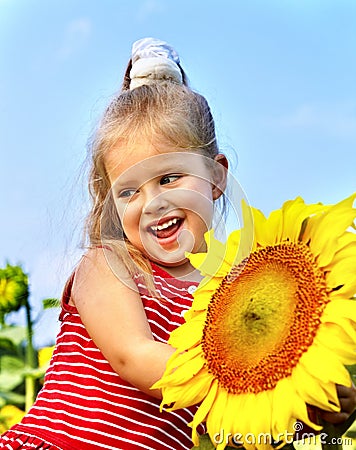 Kid holding sunflower outdoor. Stock Photo