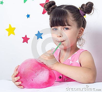 Kid inflates a big bubble from slime. Stock Photo