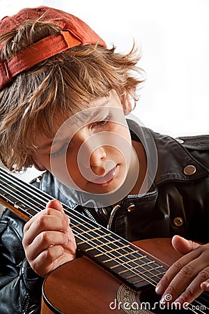 Kid learning to play guitar Stock Photo