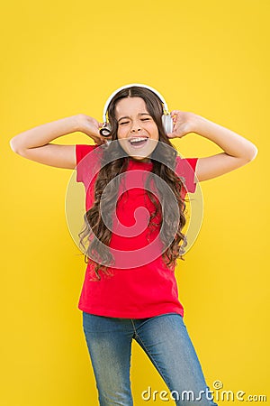 Kid listening music headphones. Music beat concept. Entertainment and fun. Top summer songs. Child or teen enjoy music Stock Photo