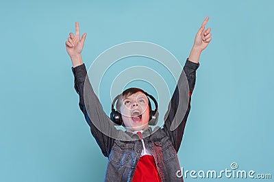 Kid listening music headphones. Music beat concept. Entertainment and fun. Child or teen enjoy music Stock Photo