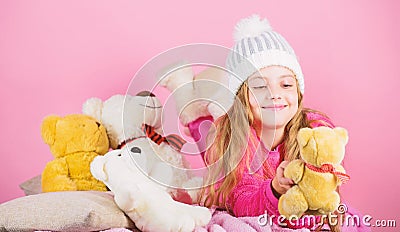Kid little girl play with soft toy teddy bear pink background. Softness is key. Child small girl playful hold teddy bear Stock Photo