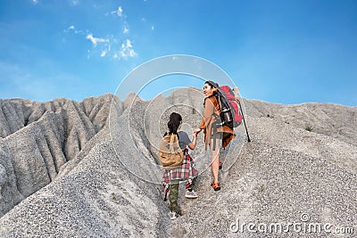 Kid and mom travel backpacks happy feeling freedom good and strong weight victorious facing on the grand canyon Stock Photo