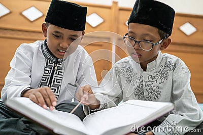 Kid muslim reading quran Stock Photo