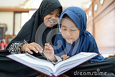 Kid muslim reading quran Stock Photo